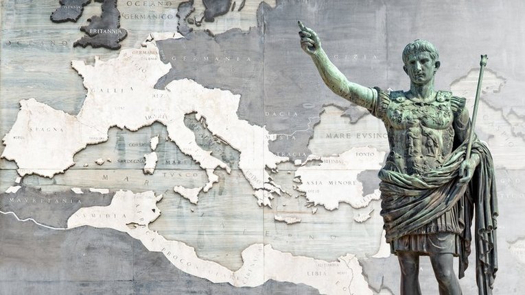 Foto einer Statue vor einer Karte des römischen Reichs